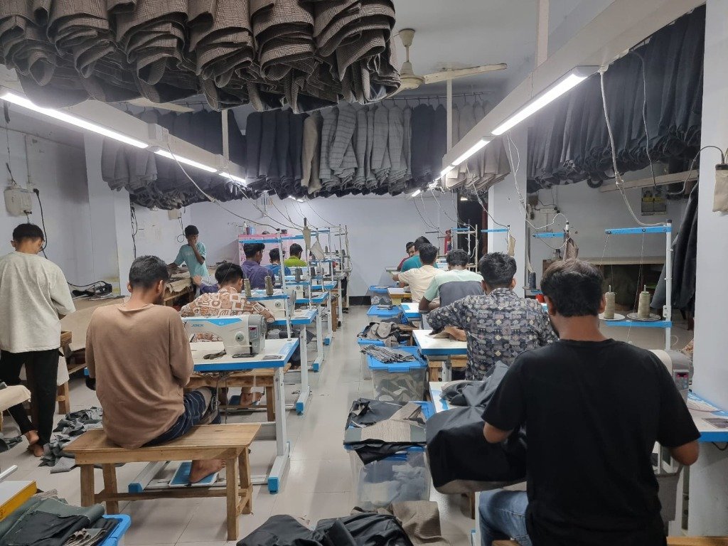 Wide view of sewing floor — workers at JACK industrial machines